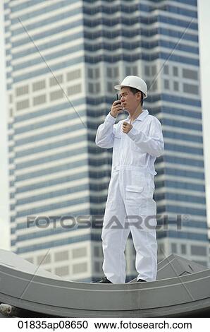 Man with walkie talkie giving directions View Large Photo Image Stock Image - Man with walkie talkie giving directions. Fotosearch