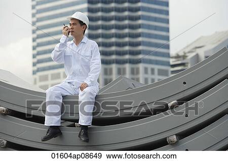 Man with walkie talkie giving directions View Large Photo Image Stock Photo - Man with walkie talkie giving directions. Fotosearch