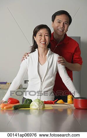 Mature couple in kitchen, smiling at camera View Large Photo Image Stock Photograph - Mature couple in kitchen, smiling at camera. Fotosearch
