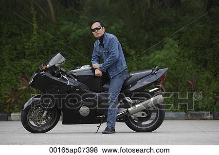 Mature man sitting on motorcycle, wearing sunglasses View Large Photo Image Stock Photo - Mature man sitting on motorcycle, wearing sunglasses. Fotosearch