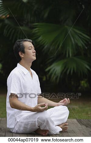 Mature man sitting outdoors practicing Yoga View Large Photo Image Stock Photo - Mature man sitting outdoors practicing Yoga. Fotosearch