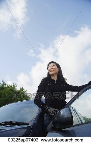Mature woman getting out of car View Large Photo Image Stock Image - Mature woman getting out of car. Fotosearch