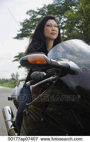 Mature woman riding motorcycle, wearing sunglasses View Large Photo Image Stock Photo - Mature woman riding motorcycle, wearing sunglasses. Fotosearch