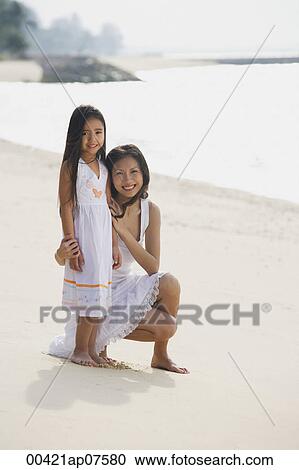 Mother and daughter on beach wearing white dresses, portrait View Large Photo Image Stock Image - Mother and daughter on beach wearing white dresses, portrait. Fotosearch