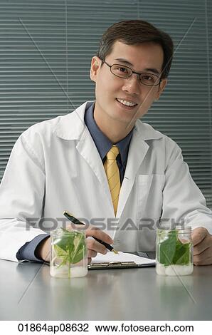 Scientist examining jar with plant samples View Large Photo Image Stock Image - Scientist examining jar with plant samples. Fotosearch