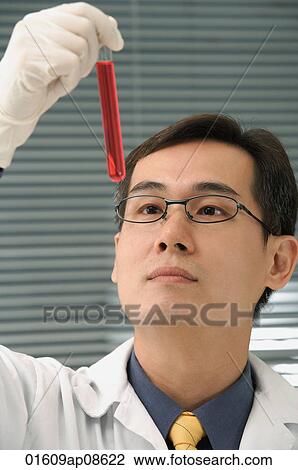 Scientist examining test tube View Large Photo Image Stock Image - Scientist examining test tube. Fotosearch