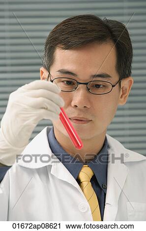 Scientist examining test tube View Large Photo Image Stock Image - Scientist examining test tube. Fotosearch
