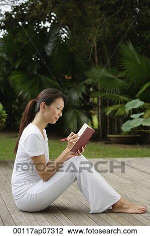 side profile of Woman sitting on porch in tropical setting, writing in diary, journal. View Large Photo Image Stock Image - side profile of Woman sitting on porch in tropical setting, writing in diary, journal.. Fotosearch
