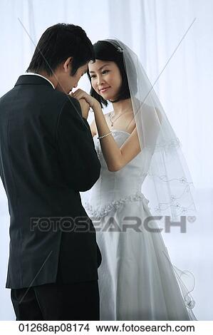 The groom kisses the brides hand View Large Photo Image Picture - The groom kisses the brides hand. Fotosearch