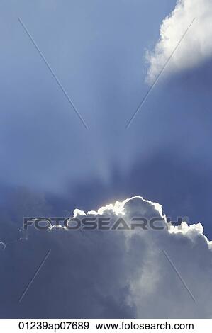 The sun shining from behind clouds View Large Photo Image Stock Photo - The sun shining from behind clouds. Fotosearch