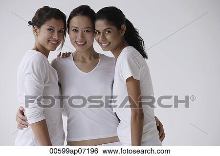 Stock Photograph - Three women facing camera, smiling, friends. Fotosearch