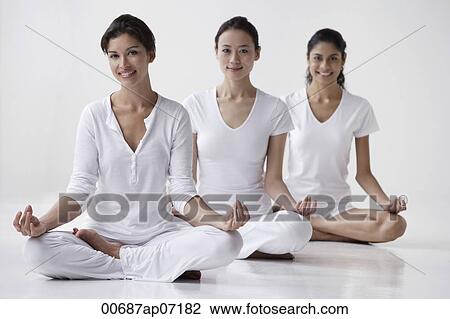 three women of mixed race sitting in yoga posture OM, meditating, looking at camera, smiling View Large Photo Image Stock Image - three women of mixed race sitting in yoga posture OM, meditating, looking at camera, smiling. Fotosearch