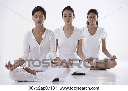 three women sitting in yoga posture OM, meditating, eyes closed View Large Photo Image Stock Image - three women sitting in yoga posture OM, meditating, eyes closed. Fotosearch