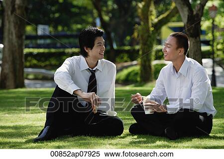 Two men eat their lunch together in the park View Large Photo Image Stock Photography - Two men eat their lunch together in the park. Fotosearch