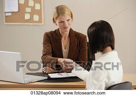 Two woman shake hands at work View Large Photo Image Picture - Two woman shake hands at work. Fotosearch