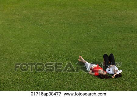 Two women relaxing in the park View Large Photo Image Stock Photo - Two women relaxing in the park. Fotosearch