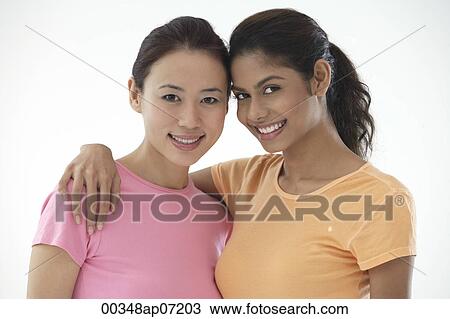 Two women smiling at camera, portrait View Large Photo Image Stock Image - Two women smiling at camera, portrait. Fotosearch