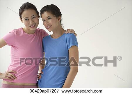 two women smiling, looking at camera View Large Photo Image Stock Photo - two women smiling, looking at camera. Fotosearch