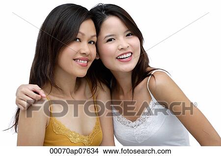 Two young women, arms around each other, smiling View Large Photo Image Picture - Two young women, arms around each other, smiling. Fotosearch