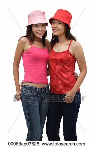 Two young women wearing red and pink, looking at camera View Large Photo Image Stock Photo - Two young women wearing red and pink, looking at camera. Fotosearch
