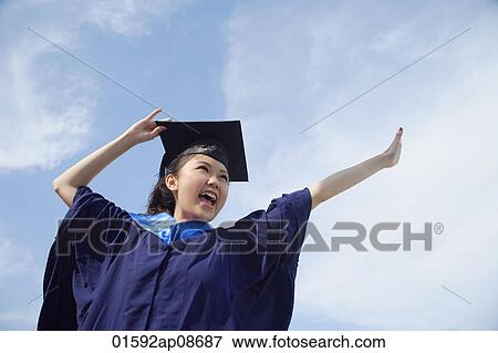 University student in graduation robe cheering View Large Photo Image Stock Photo - University student in graduation robe cheering. Fotosearch