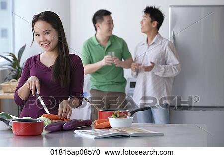 Woman cooking while men talk View Large Photo Image Stock Image - Woman cooking while men talk. Fotosearch