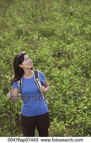 Woman hiking outdoors, nature, looking up to sky View Large Photo Image Stock Image - Woman hiking outdoors, nature, looking up to sky. Fotosearch