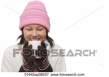 Woman holding a cup and smiling View Large Photo Image Stock Photo - Woman holding a cup and smiling. Fotosearch