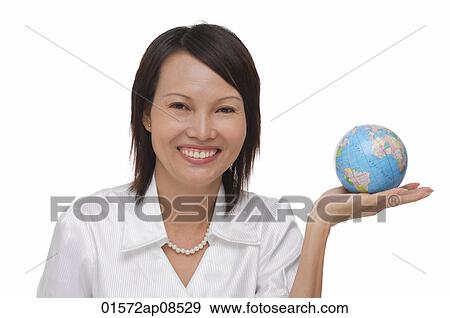 Woman holding globe and smiling at camera View Large Photo Image Stock Photo - Woman holding globe and smiling at camera. Fotosearch