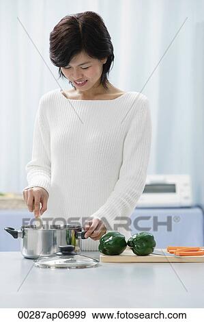 Woman in kitchen, cooking View Large Photo Image Stock Photo - Woman in kitchen, cooking. Fotosearch