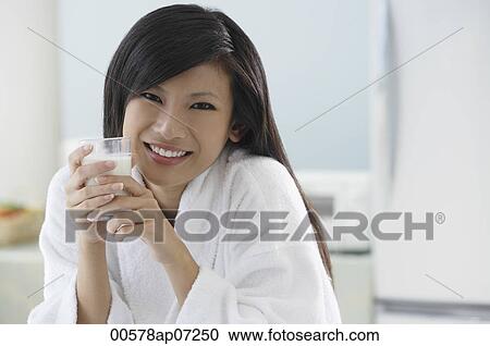 woman in kitchen, holding glass of milk, smiling at camera View Large Photo Image Stock Image - woman in kitchen, holding glass of milk, smiling at camera. Fotosearch