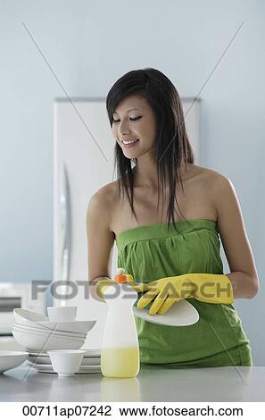 woman in kitchen, washing dishes, cleaning View Large Photo Image Stock Image - woman in kitchen, washing dishes, cleaning. Fotosearch