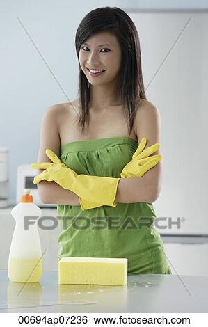 woman in kitchen with cleaning products, arms crossed, smiling at camera View Large Photo Image Stock Photograph - woman in kitchen with cleaning products, arms crossed, smiling at camera. Fotosearch