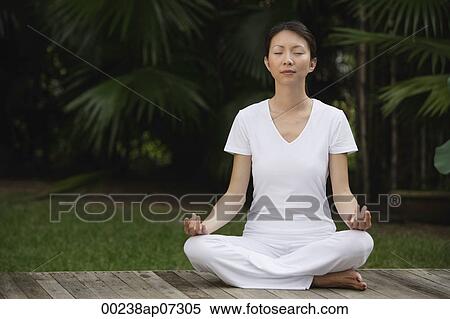 Woman in tropical setting, meditating on porch, eyes closed, in yoga OM posture. View Large Photo Image Stock Photography - Woman in tropical setting, meditating on porch, eyes closed, in yoga OM posture.. Fotosearch