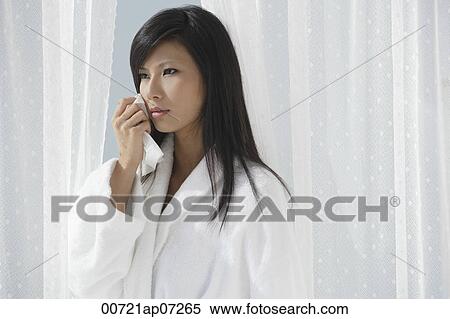 woman looking sad and wiping tears from her eyes, thinking View Large Photo Image Stock Photography - woman looking sad and wiping tears from her eyes, thinking. Fotosearch