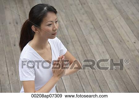 Woman on porch in yoga posture, hands in namaste, View Large Photo Image Stock Photo - Woman on porch in yoga posture, hands in namaste,. Fotosearch
