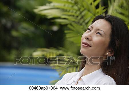 Woman outdoors, looking away, head shot View Large Photo Image Picture - Woman outdoors, looking away, head shot. Fotosearch