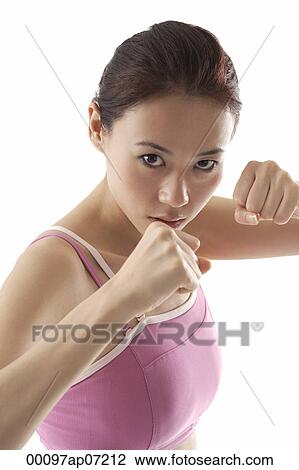 Woman standing in fighting position, boxing, looking at camera View Large Photo Image Stock Image - Woman standing in fighting position, boxing, looking at camera. Fotosearch