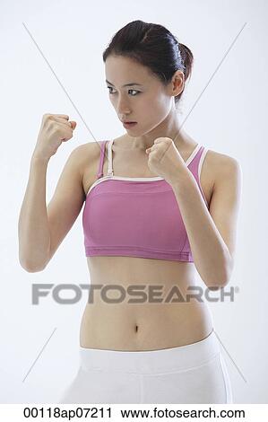 Woman standing in fighting stance, boxing View Large Photo Image Stock Image - Woman standing in fighting stance, boxing. Fotosearch