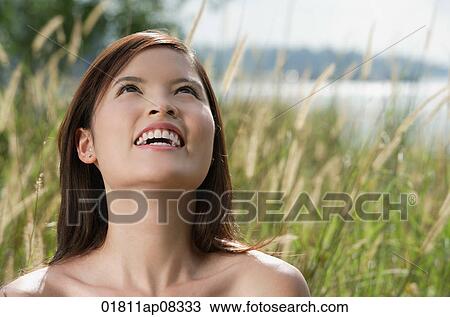 Woman standing in long grass View Large Photo Image Stock Image - Woman standing in long grass. Fotosearch