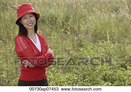 woman standing outdoors in nature, smiling at camera View Large Photo Image Stock Image - woman standing outdoors in nature, smiling at camera. Fotosearch
