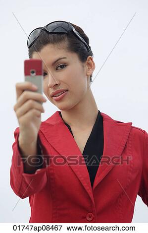 Woman taking picture with mobile phone View Large Photo Image Stock Photo - Woman taking picture with mobile phone. Fotosearch