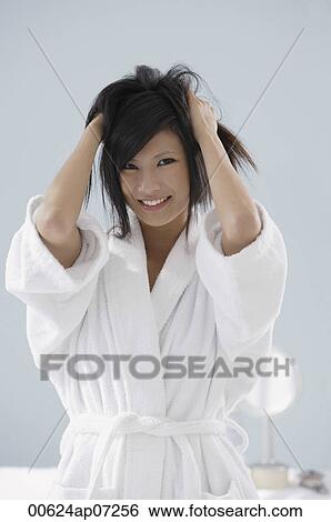 woman wearing bathrobe and running hands through hair, smiling View Large Photo Image Stock Photograph - woman wearing bathrobe and running hands through hair, smiling. Fotosearch