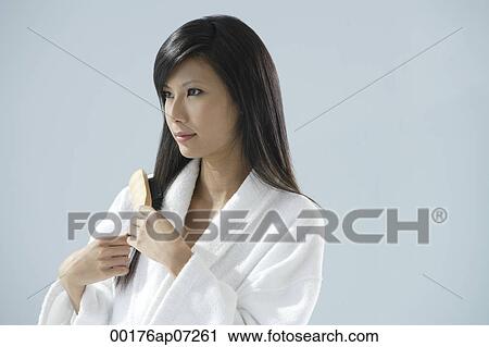 woman wearing bathrobe, brushing hair and looking away from camera View Large Photo Image Stock Image - woman wearing bathrobe, brushing hair and looking away from camera. Fotosearch