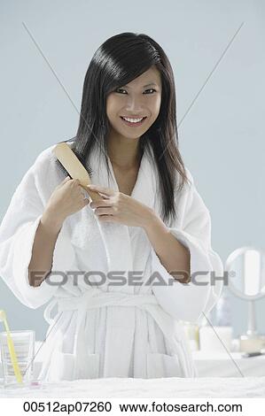 woman wearing bathrobe, brushing hair and smiling at camera View Large Photo Image Stock Image - woman wearing bathrobe, brushing hair and smiling at camera. Fotosearch