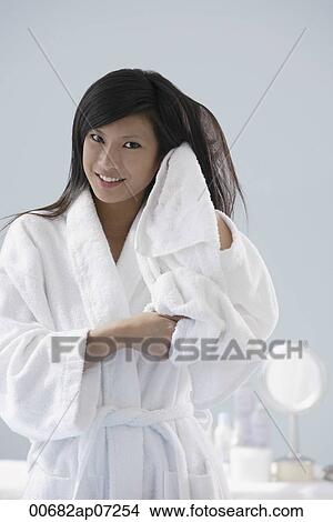woman wearing bathrobe, towel drying hair, smiling at camera View Large Photo Image Picture - woman wearing bathrobe, towel drying hair, smiling at camera. Fotosearch