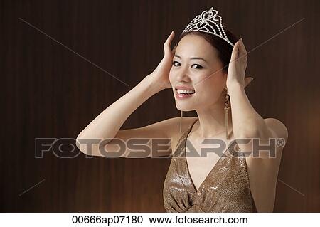 woman wearing crown, hands on crown on head, smiling at camera View Large Photo Image Stock Image - woman wearing crown, hands on crown on head, smiling at camera. Fotosearch