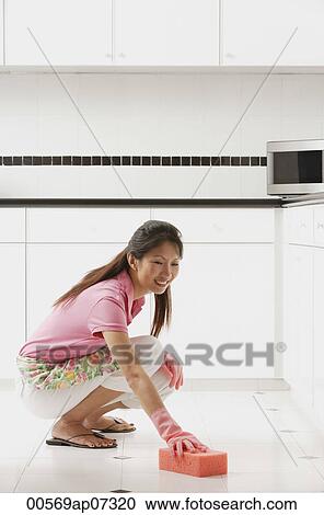 woman wearing gloves cleaning kitchen floor View Large Photo Image Stock Image - woman wearing gloves cleaning kitchen floor. Fotosearch
