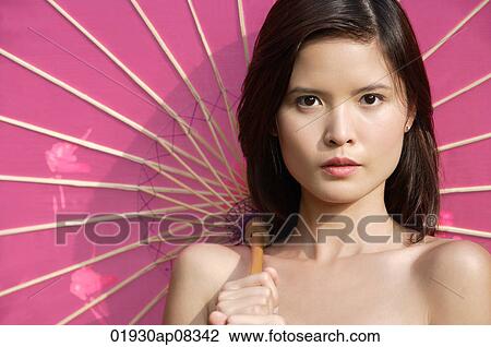 Woman with pink parasol looking at camera View Large Photo Image Stock Image - Woman with pink parasol looking at camera. Fotosearch