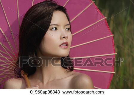 Stock Image - Woman with pink parasol. Fotosearch